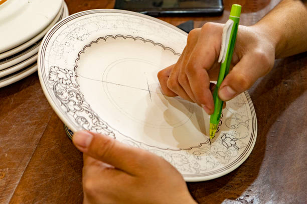 istock a man drawing the design in a plate 2093406161
