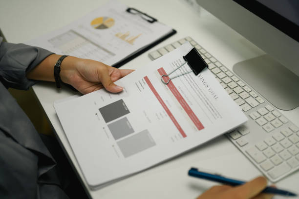 istock Unrecognizable businesswoman working with financial documents at her workplace 2093408777