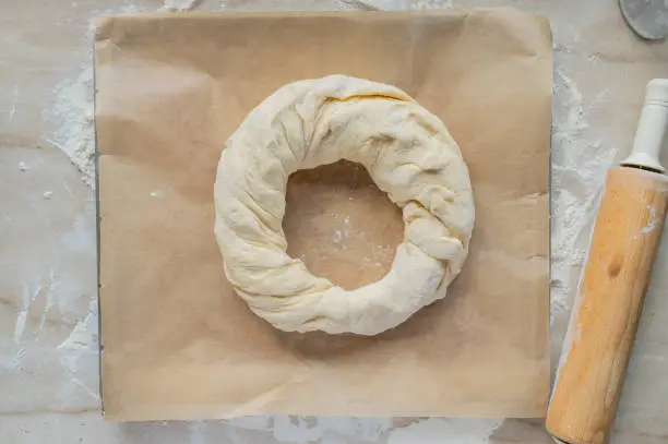 Yeast wreath fresh shaped on a baking sheet ready to bake. Real life