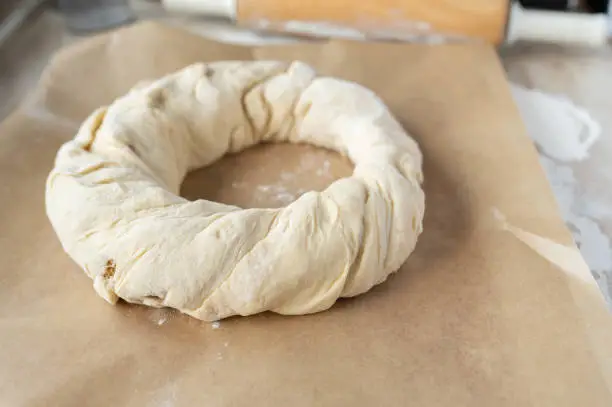 Yeast wreath fresh shaped on a baking sheet ready to bake. Real life