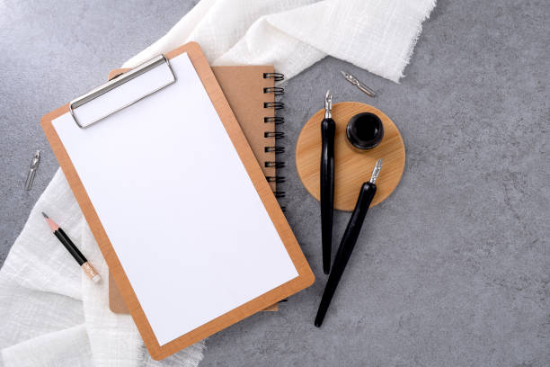 istock Blank clipboard with dip pen on stone texture background. Writer workplace concept. 2093415983