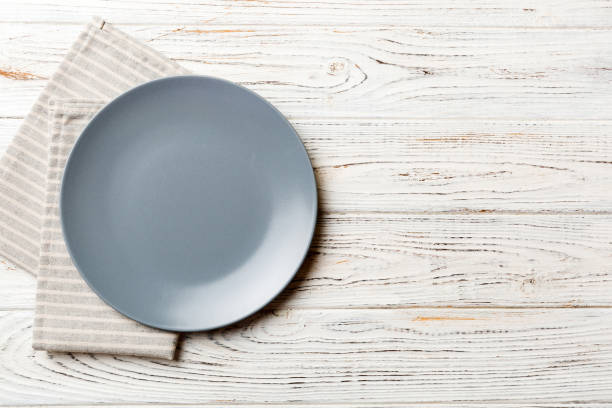 istock Top view on colored background empty round gray plate on tablecloth for food. Empty dish on napkin with space for your design 2093418651