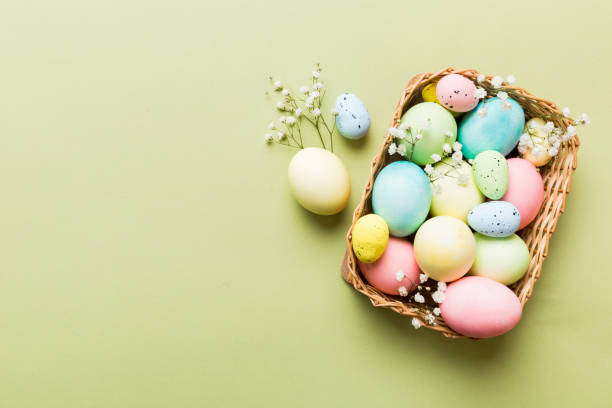 istock Happy Easter composition. Easter eggs in basket on colored table with gypsophila. Natural dyed colorful eggs background top view with copy space 2093418694
