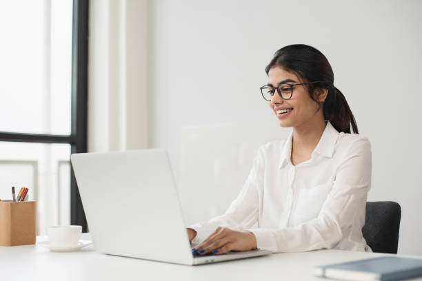 istock Woman working in office. Student girl using laptop computer at home 2093422030