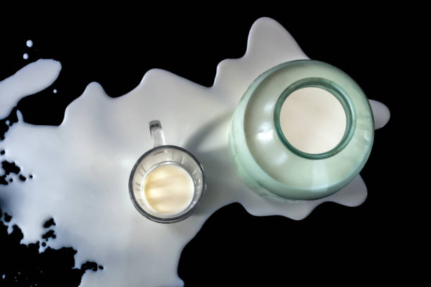 istock Drinking cow's milk in a cup on a black background 2093454345