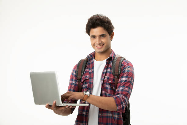 istock Portrait of positive joyful Indian  man using laptop and looking at camera. 2093454879