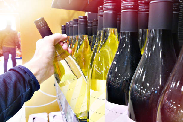 istock Bottle of white wine on hand 2093472128