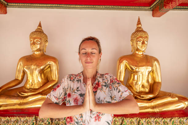 She makes a namaste prayer pose with hands, happy to discover the gems in Asia