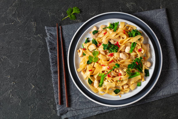 istock rice noodles with chicken, eggs, chinese broccoli 2093505793