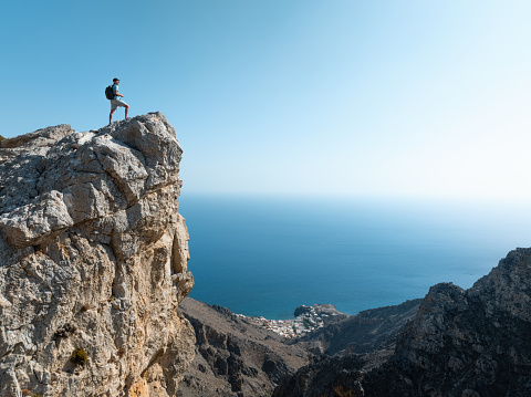 Man standing on top of Abas gorge in Crete watching down to Tris Ekklisies village.