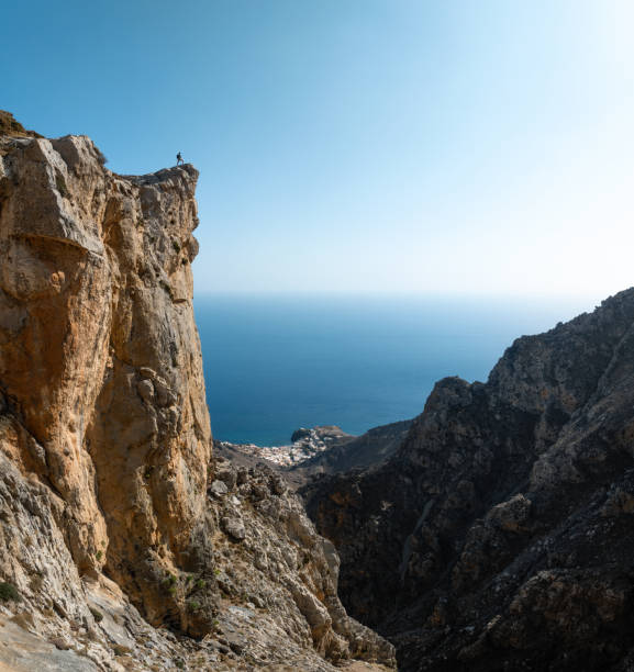 istock Man Standing On The Edge Of The Cliff 2093510517