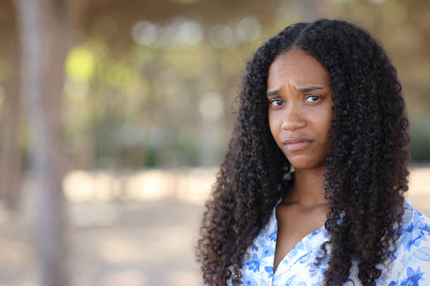istock Disappointed black woman looking at camera in a park 2093511596