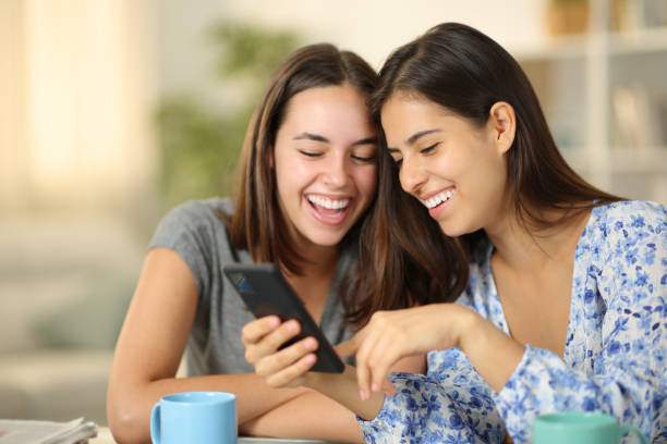 istock Happy women checking online content on phone at home 2093513704