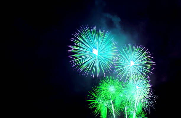 istock Stunning Vibrant blue and green fireworks exploding in to the night sky 2093523125