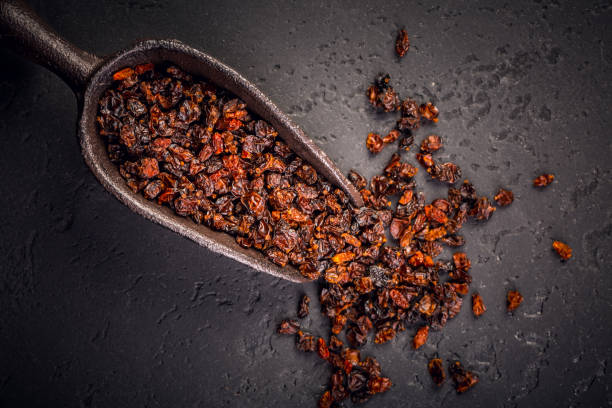 istock Organic dried berberis and scoop on black blackground 2093526852
