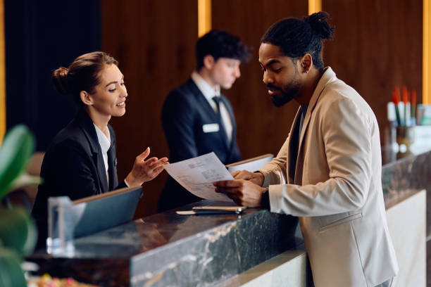 istock African American man checking in at reception desk in a hotel. 2093529530