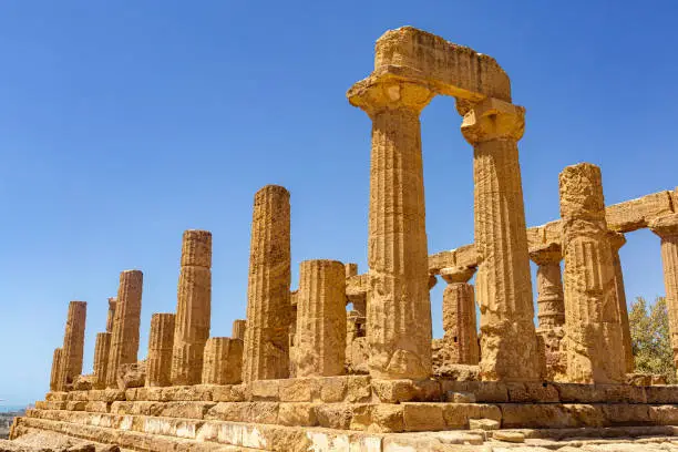 Photo of Columns of Temple of Heracles. The Valley of the Temples in Agrigento, archaeological heritage. Hellenic, Greek architecture in Sicily, Italy, famous tourist place, no people. August 2023.