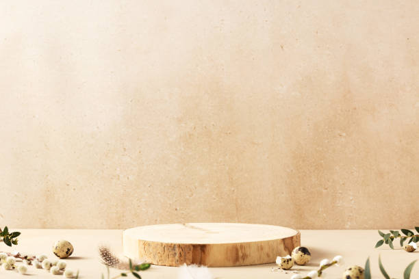 istock Empty round wooden podiums, quail eggs with green eucalyptus branches on a beige background 2093567918