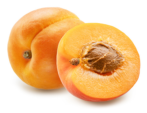 Ripe apricot and apricot half on white background. File contains clipping path.