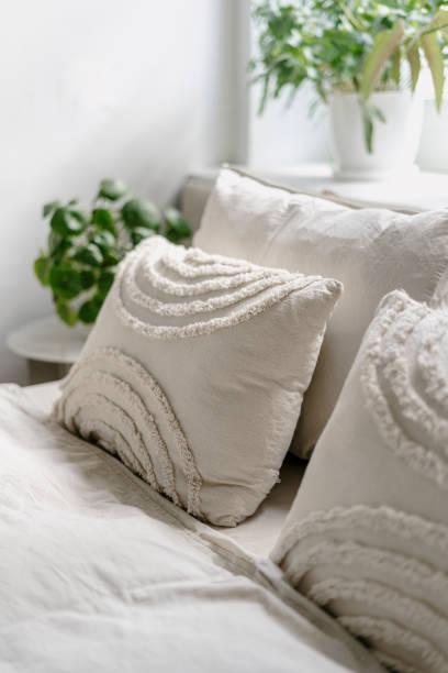 istock Decorative linen cushions in boho style on comfort bed in cozy bedroom 2093609464