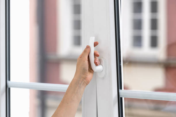 istock Selective focus on female hand turning handle up and opening window at apartment. 2093609989
