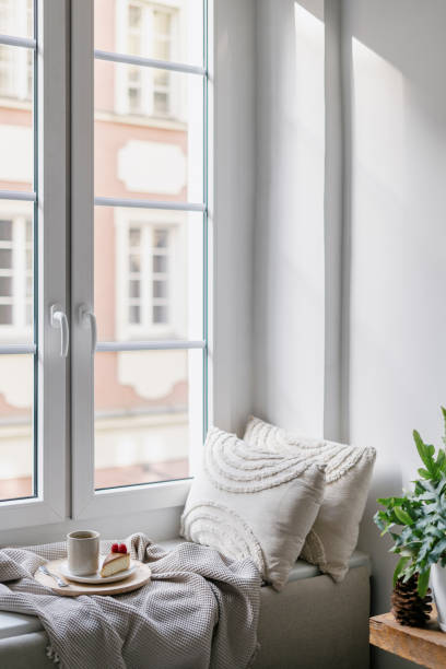 istock Comfort windowsill with decorative cushions, soft plaid, coffee and cheesecake 2093609992
