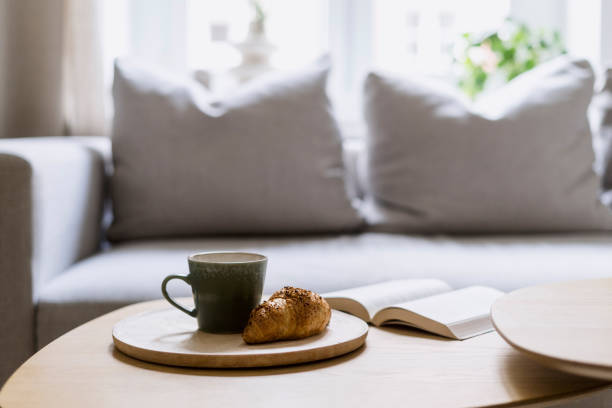istock Selective focus on wooden plate with croissant and cup with coffee on table. 2093610519