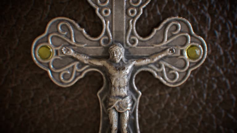 A metal crucifix adorning a leather-bound religious text