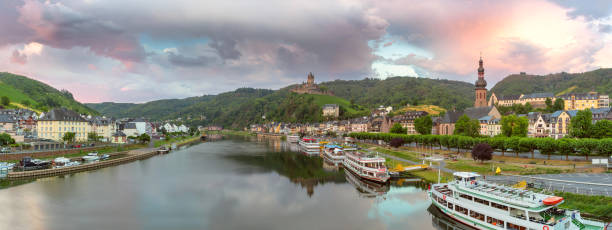 Beautiful high angle city view of historic old town Cochem with the typical half-timbered colorful houses, hotels and restaurants, Reichsburg Imperial castle landmark on a mountain, Mittelmosel, Moselle river, Rhineland-Palatinate in rainy spring time Rheinland-Pfalz Deutschland, Europe