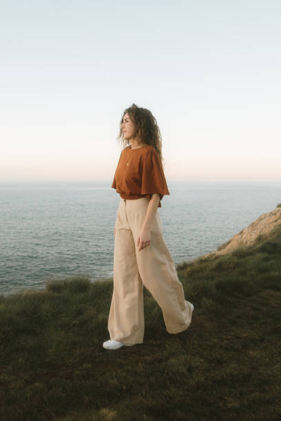 istock Woman walking by the sea 2093644897