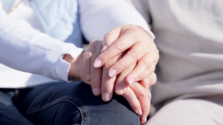 Closeup of senior couple holding hands