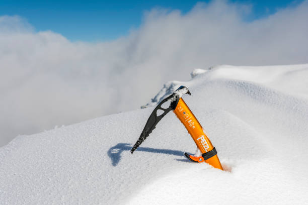 Zakopane, Poland - March 17, 2024: Petzl Gully ice axe in the snow on a peak in the mountains.