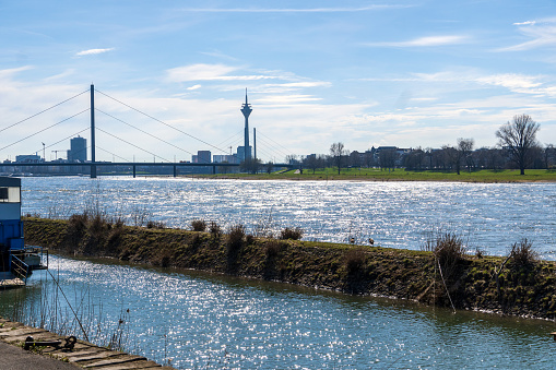 Düsseldorf, Germany, March 2024: View to Rheinturm Tower from the Rhine Promenade at Robert-Lehr-Ufer