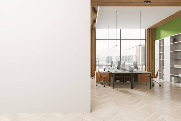 istock Business interior with pc computers on desk, shelf with window. Mock up wall 2093676057
