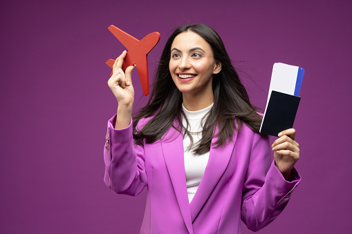 Portrait of her she nice well-dressed attractive lovely luxury pretty content cheerful girl holding in hands paper documents boarding pass departure isolated on purple background