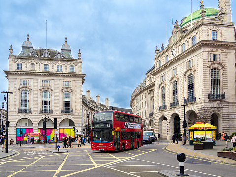 London, United Kingdom - February 26, 2024: The red tourist bus in London arriving from Regent Street to the Piccadilly Circus
