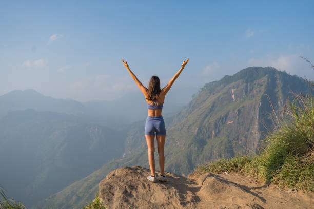 istock Young woman on top of mountain 2093697201