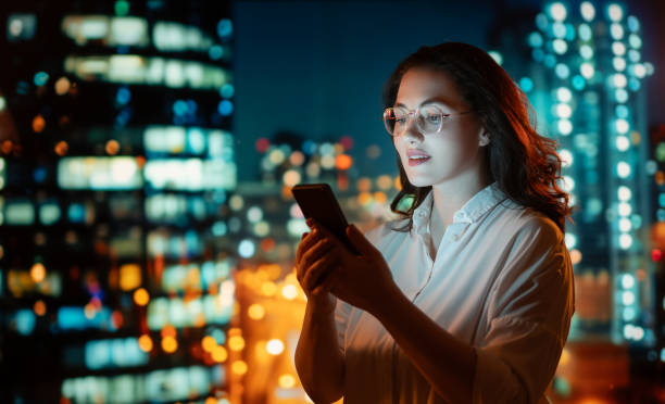 istock businesswoman using phone near window 2093704978