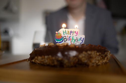 Close up of chocolate Birthday cake with candle on top of it. Copy space.