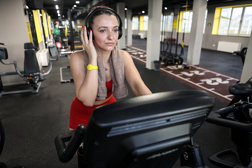 Young woman exercising in a gym. About 30 years old, Caucasian brunette.