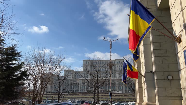 BUCHAREST, ROBUCHAREST, ROMANIA Palace of the Parliament Boulevard full of trees to Parliament cars moving on empty road, europe landmarkMANIA - JUNE, 3