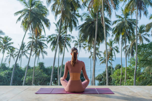 istock Young woman performs yoga outdoors 2093744095