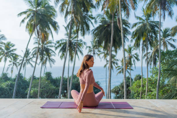 istock Young woman performs yoga outdoors 2093744123