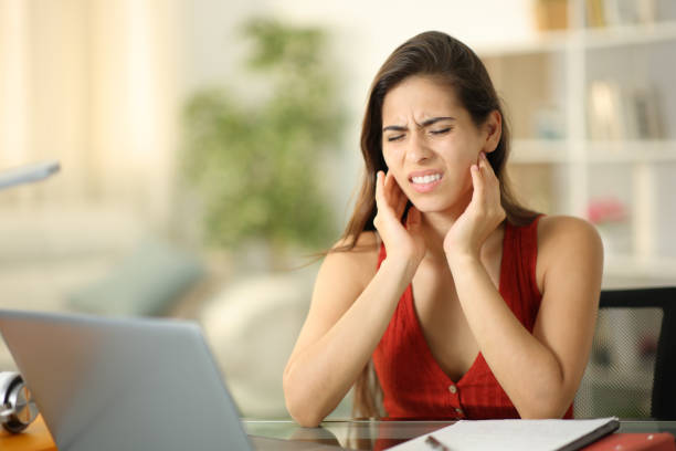 Stressed student suffering temporomandibular ache