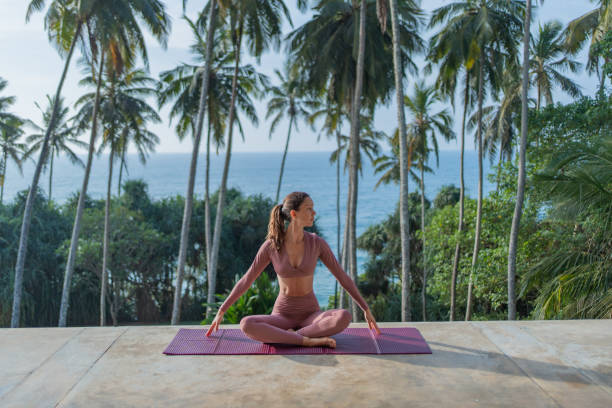 istock Young woman performs yoga outdoors 2093753779