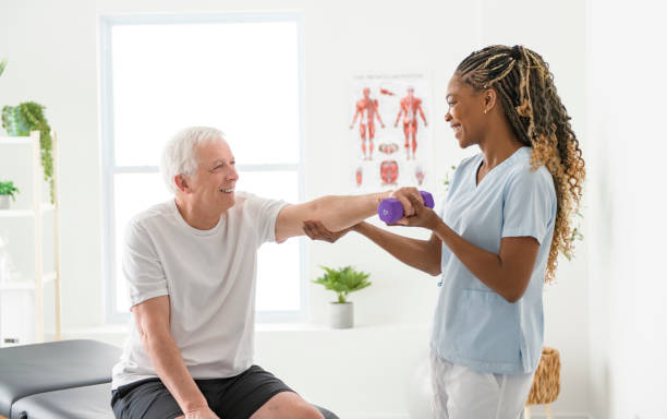 istock Black physiotherapist helping senior man with in clinic. Elderly man undergoing physiotherapy treatment for injury 2093760734