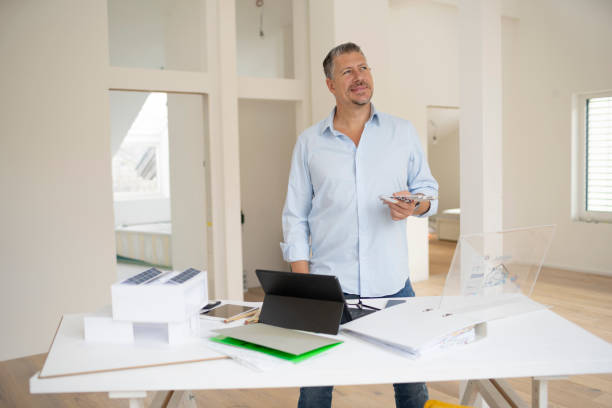 istock male architect is working in modern office, standing on table, loft, working with transparent tablet, monitor 2093761336