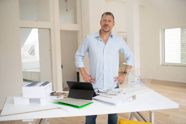 istock male architect is working in modern office, standing on table, loft, working with transparent tablet, monitor 2093761388