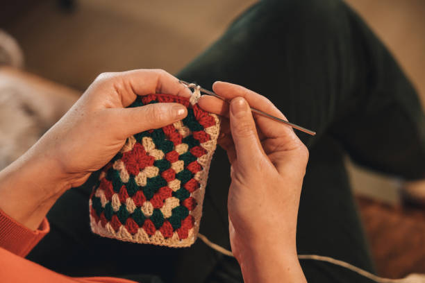 istock Unrecognizable woman knitting a crocheted rug 2093761831