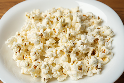 A plate full of popcorn.